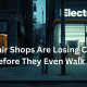 A consumer walks down a city street toward a brightly lit electronics retailer while a small independent tech repair shop sits dimly lit nearby. The image highlights the growing challenge repair businesses face competing with the convenience, visibility, and accessibility of replacement electronics in 2026.